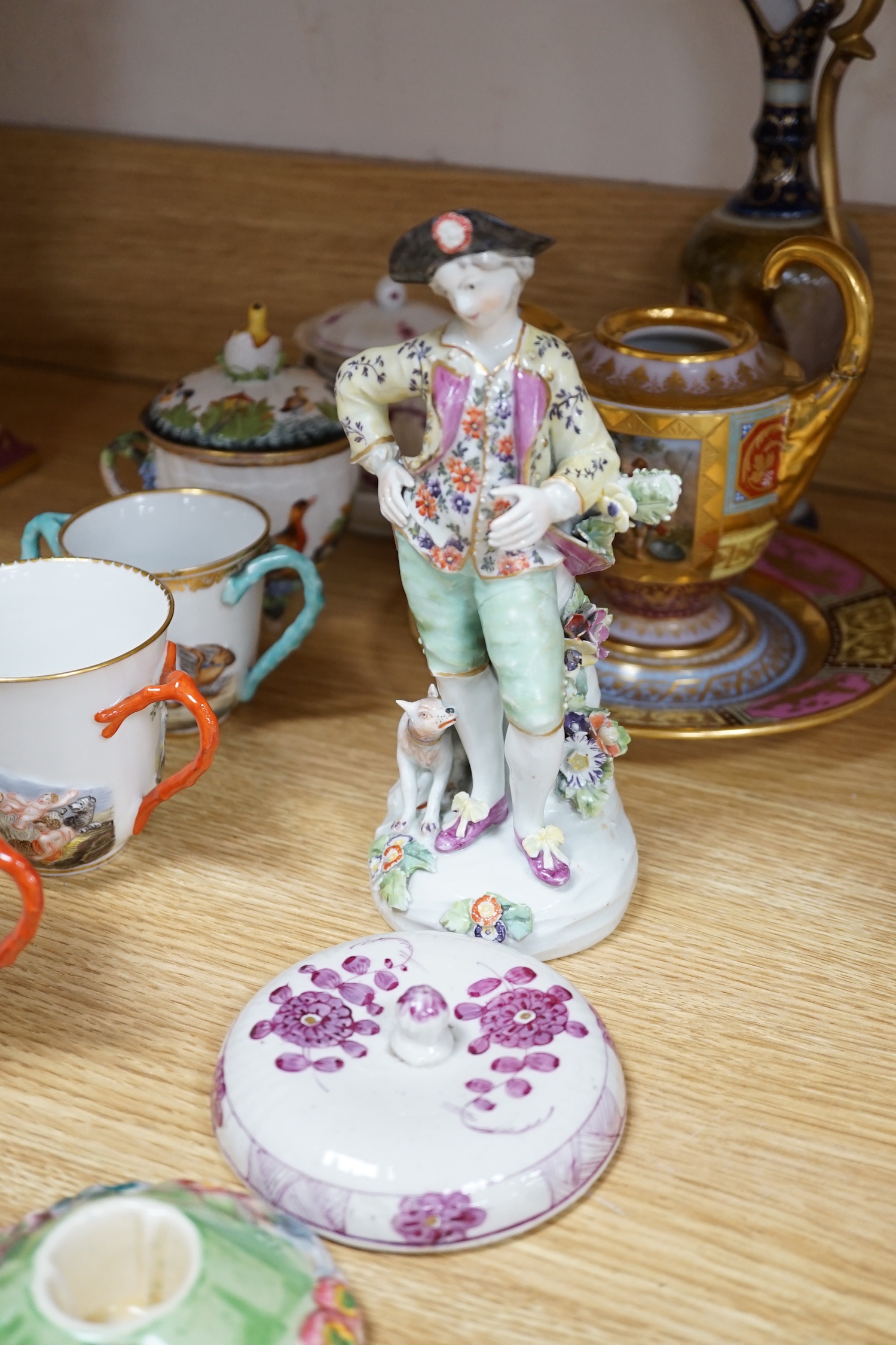 19th century Continental tableware, including Richard Ginori Capodimonte style cups and a porcelain figure group of a gentleman and dog, largest 25cm high